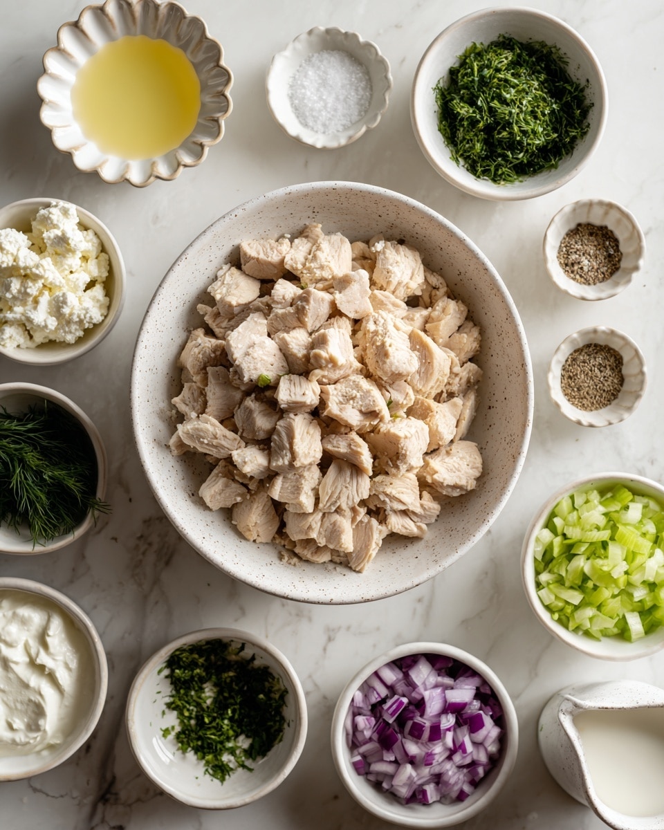 A white speckled bowl in the center holds a pile of chopped light brown cooked chicken pieces. Surrounding it are smaller white bowls arranged in a loose circle on a white marbled surface: top left shows a white scalloped bowl with light yellow lemon juice, next to it a small white bowl with white salt, then white bowl with green chopped dill, a small white bowl with light beige minced garlic, a small white bowl with black pepper, white bowl with dark green chopped parsley, a white bowl with shredded pale green celery fused with parsley, a white bowl with chopped purple onion, a white bowl with chopped dark green celery, a white bowl with light green chopped cucumber, and a small white measuring cup holding white crumbled feta cheese. A small white measuring cup with thick white yogurt is also near the center. Photo taken with an iphone --ar 4:5 --v 7
