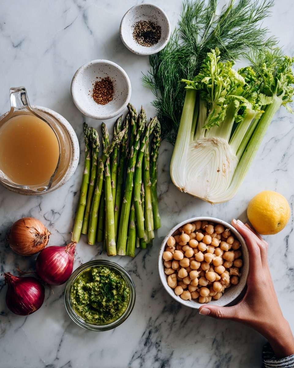 The image shows a white marbled surface with seven small white bowls and fresh vegetables arranged neatly. Starting from the top left, there is a small white bowl with a dark spice next to a small amount of leafy dill and celery stalks standing upright. Below them are fresh asparagus spears laid out in a row beside a fennel bulb with feathery green tops. To the right, a small white bowl holds light beige chickpeas, while below that is a bowl filled with a green herb sauce. Near the bottom left corner, there are red onions and a yellow lemon, with a clear glass jug filled with light brown liquid placed close by. A woman's hand gently holds an onion from the left side of the arrangement. photo taken with an iphone --ar 4:5 --v 7
