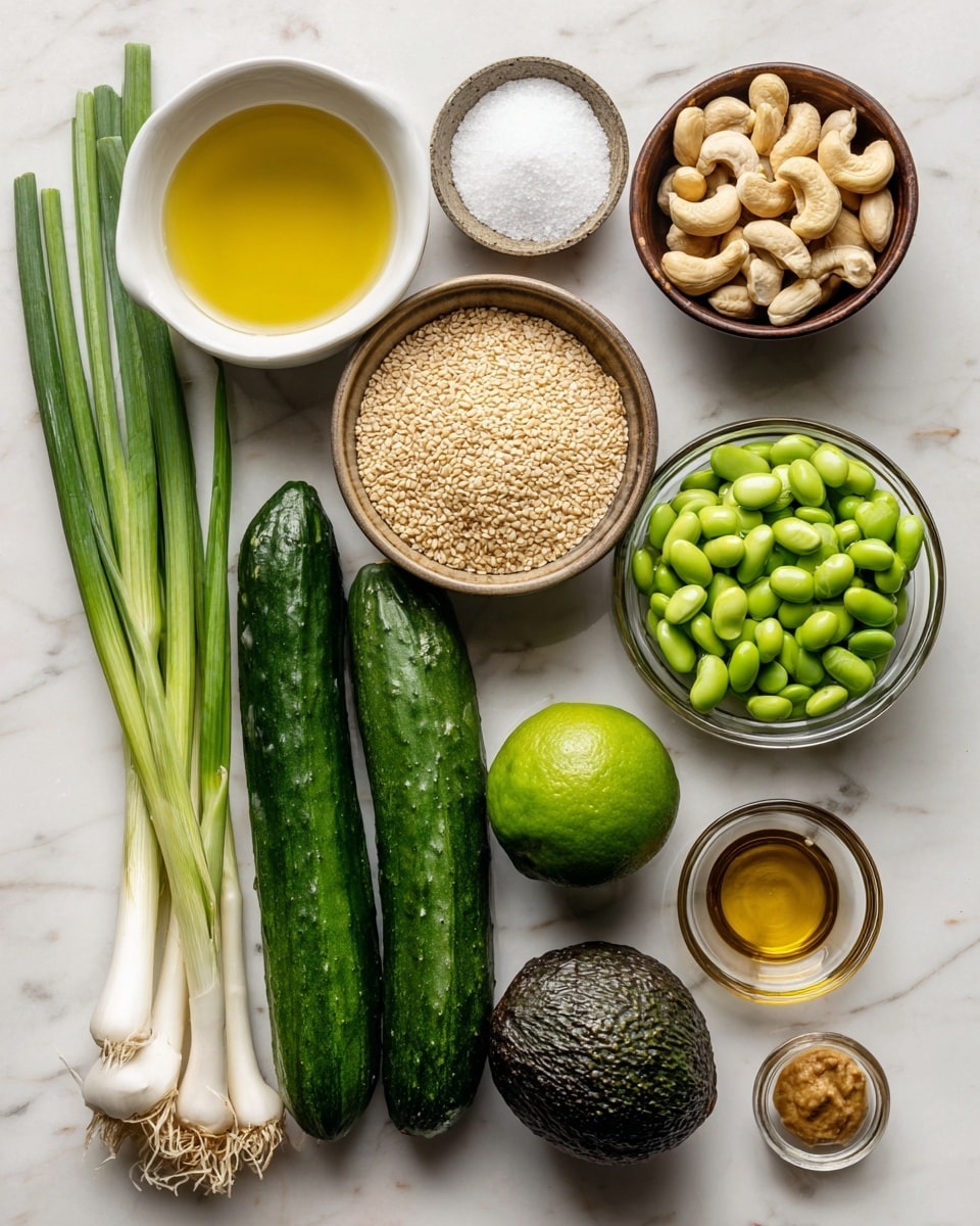 A flat lay image showing several fresh ingredients arranged neatly on a white marbled surface. From left to right, there is a white bowl filled with light yellow seasoned rice vinegar, beside it a small brown bowl with beige sesame seeds, below that another small brown bowl with white sugar, and a third small brown bowl holding golden toasted sesame oil. Next is a larger brown bowl with light brown miso paste. Below these, three fresh dark green cucumbers sit side by side. In the center, there is a whole green lime and a dark green, textured avocado. To the right of these, a clear glass bowl filled with bright green edamame beans is placed near a bunch of long, fresh green onions with white roots. Above them lie three cloves of white garlic and a clear glass bowl filled with whole cashews. The overall arrangement is clean and colorful, with a focus on natural textures and fresh produce. Photo taken with an iphone --ar 4:5 --v 7
