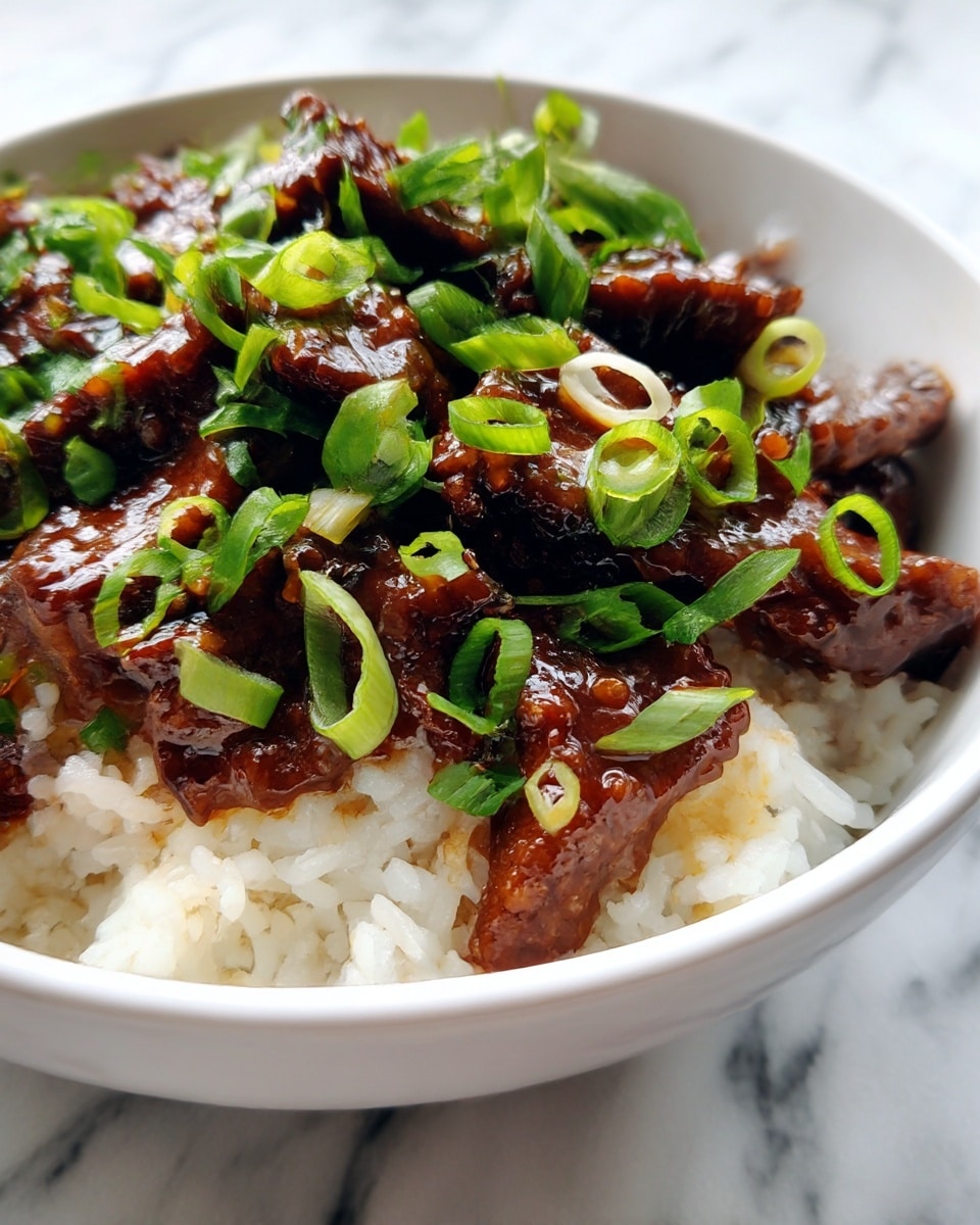 A close-up view of a white bowl filled with two main layers: the bottom layer is white rice with visible individual grains, and the top layer consists of dark brown glazed meat strips, shiny with sauce and scattered with bright green sliced onions on top. The bowl is set on a white marbled surface. photo taken with an iphone --ar 4:5 --v 7