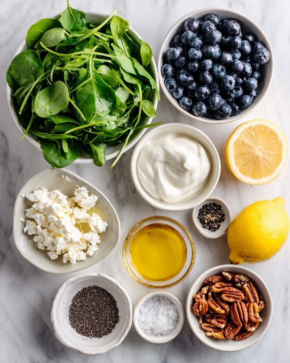 The image shows an overhead view of several small white bowls and plates arranged on a white marbled surface, each filled with different fresh ingredients. There are two large white bowls filled with different leafy greens: one with bright green baby arugula with long, thin leaves, and the other with darker green baby spinach with soft, smooth leaves. Smaller white bowls hold deep blue, round blueberries; small, crumbly white feta cheese; creamy white Greek yogurt; golden yellow olive oil; dark brown toasted pecans with a rough texture; sticky golden honey with a smooth surface; tiny black poppy seeds; coarse white salt; and a bright yellow lemon with a smooth rind. The bowls are closely grouped together, showing a variety of textures and natural colors, with the leafy greens providing a lush green base. Photo taken with an iphone --ar 4:5 --v 7