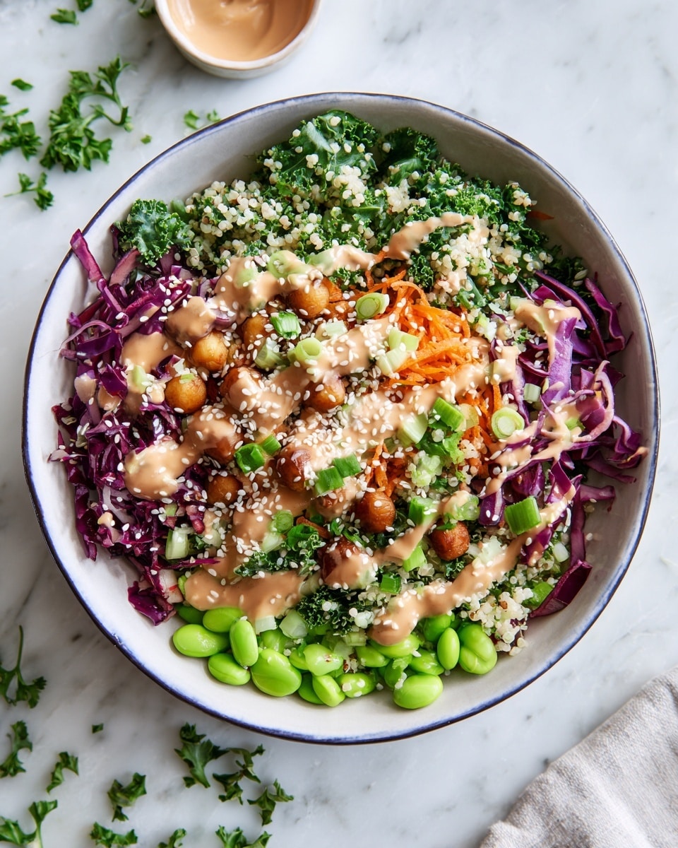 A bowl filled with a colorful mixed salad sits on a white marbled surface. The salad has about four layers visible: a base of finely chopped green kale and purple cabbage, mixed with small orange carrot shreds, chopped green onions, and light green edamame beans. There are also small white quinoa grains and chickpeas spread throughout. On top, a light brown creamy dressing is drizzled evenly, with white sesame seeds sprinkled over it. The bowl is white with a thin dark blue rim, and some fresh green herbs are scattered around the bowl and on the surface nearby. Photo taken with an iphone --ar 4:5 --v 7