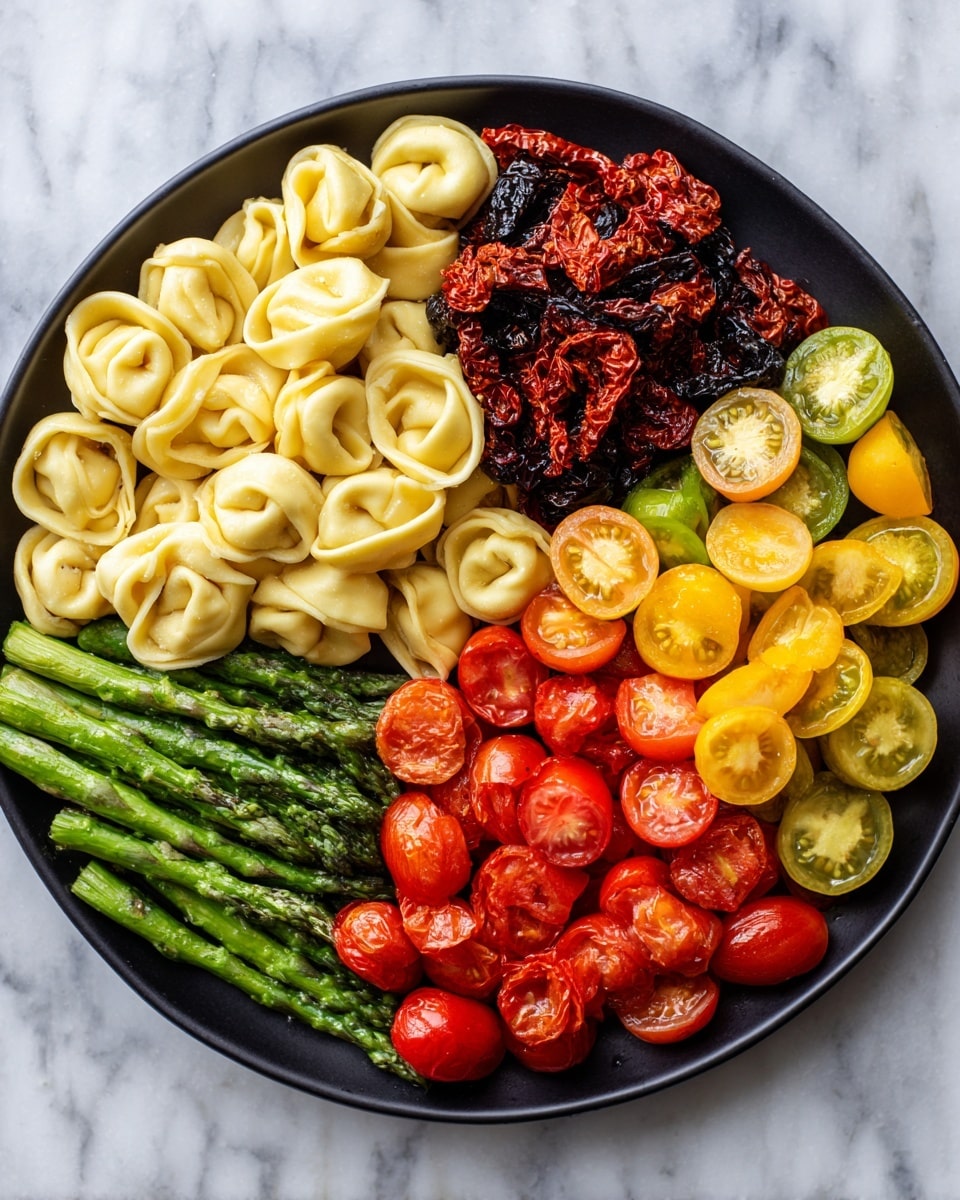 Pesto Chicken Tortellini and Veggies Recipe 5 The image shows a close-up of a stainless steel pan with four main sections of food. On the left side, there is a layer of yellow tortellini pasta covered lightly with green pesto sauce. To the right of the pasta, there is a section of small pieces of cooked chicken mixed with halved red and yellow cherry tomatoes. Below the chicken and tomatoes, there is a bunch of bright green cooked asparagus spears with some halved cherry tomatoes scattered on top. The colors are vibrant, and the textures include smooth pasta, tender chicken, juicy tomatoes, and crisp asparagus. The dish is placed on a white marbled surface photo taken with an iphone --ar 4:5 --v 7