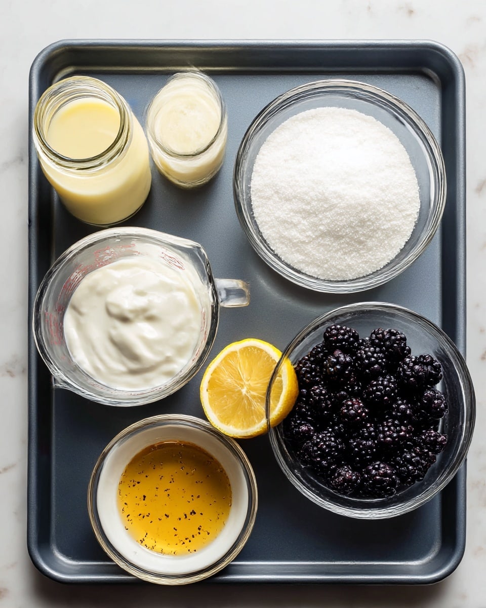 A dark gray baking tray sits on a white marbled surface, holding six clear glass containers and one lemon half. In the top left, a small glass jar is filled with light yellow sweetened condensed milk. Next to it on the right, a round glass bowl holds white granulated sugar. Below the jar, a glass measuring cup contains thick white heavy cream. To the right of the cream, a halved lemon shows bright yellow flesh. At the bottom left, a small white bowl holds golden vanilla extract with specks of vanilla bean. The largest round glass bowl at the bottom right is full of dark mulberries with shades of deep purple and black. All items are neatly arranged on the tray, photo taken with an iphone --ar 4:5 --v 7