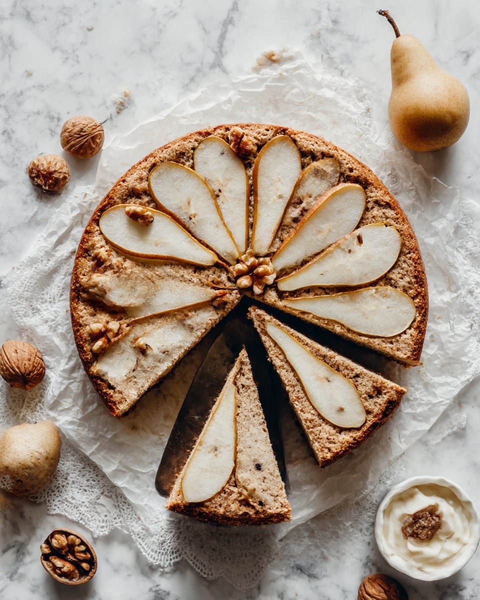 A round cake placed on parchment paper and a white lace cloth is shown with one slice being lifted by a metal spatula. The cake has a rough texture with a light brown color. The top layer has thin slices of pears arranged in a circular pattern, with small pieces of walnuts scattered over. The slice being lifted reveals a soft, dense inside with small dark spots that look like nuts or spices. Surrounding the cake, there are whole walnuts, whole pears, and a small white bowl with a creamy substance. The background is a white marbled texture. photo taken with an iphone --ar 4:5 --v 7