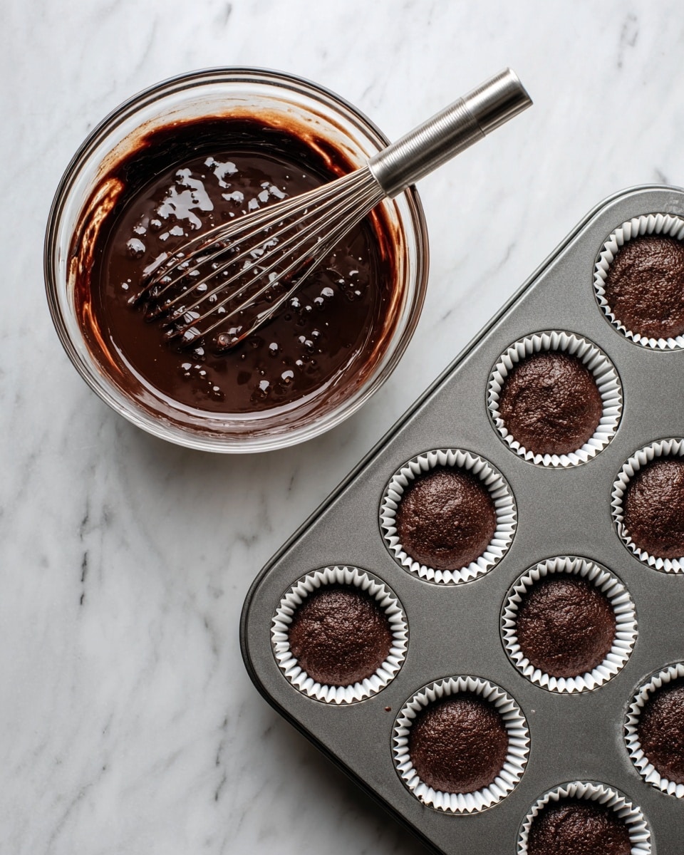 The image shows a dark chocolate cupcake with three main layers. The bottom layer is a moist, rich chocolate cake with a dark brown, soft texture, partially wrapped in a slightly peeled back brown cupcake liner. The middle layer is a thick white cream topping with small dark specks, fluffy and swirled high above the cake surface. On top of the cream is dark chocolate drizzle streaked thinly and unevenly. The last layer is a whole round dark chocolate sandwich cookie inserted vertically into the cream at the back center. In the background, several similar cupcakes with the same layers and decoration are slightly blurred, all placed on a white marbled surface with a purple background. photo taken with an iphone --ar 4:5 --v 7