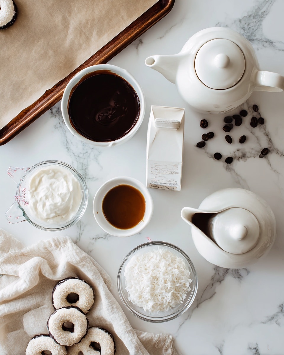 A white teapot with a lid sits on the right side on a white marbled surface. Next to it, there is a white pitcher filled with dark chocolate sauce, with some coffee beans scattered around. In the center, a white carton stands upright. Below it, a small white bowl with caramel sauce and a clear glass bowl filled with white shredded coconut are placed side by side. On the bottom left, a clear measuring cup holds white cream, and a beige cloth with several chocolate-dipped ring-shaped cookies lies around it. There is also a brown baking tray with parchment paper in the top left corner, completing the scene. Photo taken with an iphone --ar 4:5 --v 7