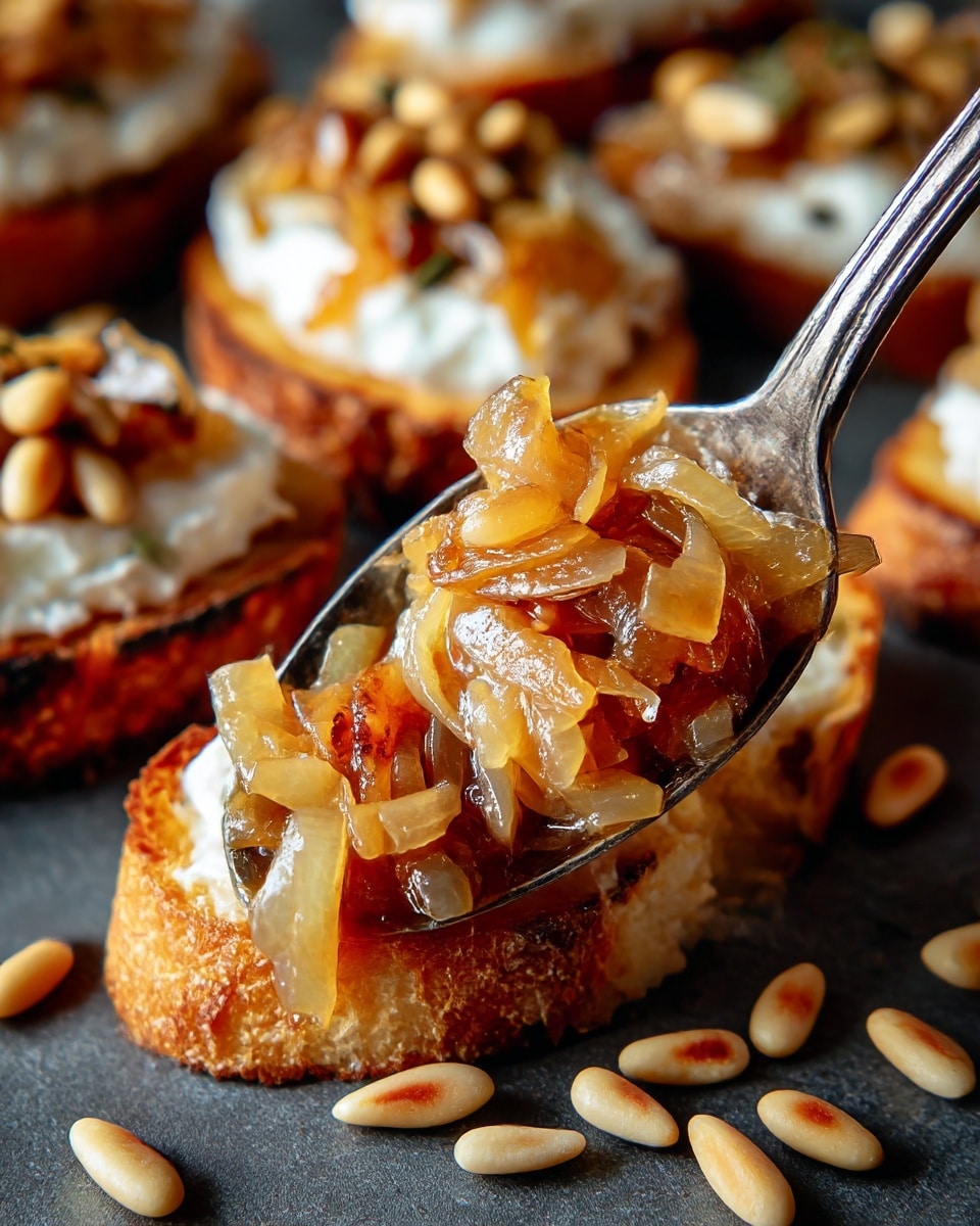 The image shows a close-up of a spoon holding a glossy pile of golden-brown caramelized onions with a soft, slightly translucent texture. The spoon rests on a dark gray surface, scattered with a few pale pine nuts, which are small, oval, and smooth. In the blurred background, there are slices of toasted bread spread with a thick white layer of creamy cheese and topped with caramelized onions and pine nuts. The toasted bread has a crispy, golden crust with a rough texture. The overall colors are warm and inviting, with soft lighting highlighting the shine on the onions and the textures of the bread and pine nuts. photo taken with an iphone --ar 4:5 --v 7