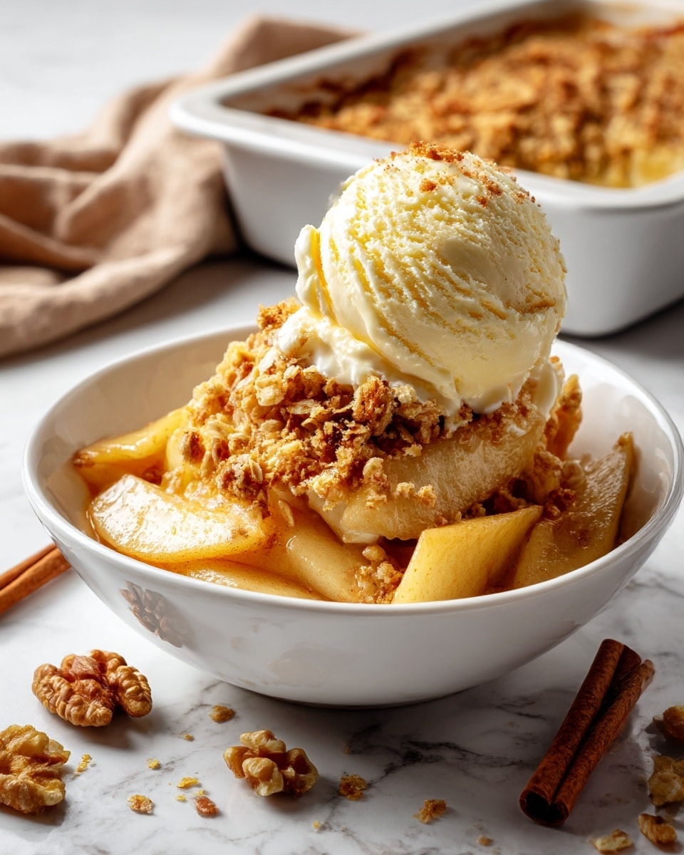 In a white bowl, there are three main layers: the bottom layer is soft cooked apple slices, which are light brown and slightly shiny, showing a tender texture; the middle layer is a crumbly, golden-brown oat and nut crumble that has a coarse texture with some nut chunks visible; on top, there is a scoop of creamy, pale yellow ice cream slowly melting over the crumble and apples. The bowl sits on a white marbled surface with scattered walnut pieces around it and a cinnamon stick to the side, while a soft, light brown cloth is partly visible in the background along with a rectangular baking dish. photo taken with an iphone --ar 4:5 --v 7