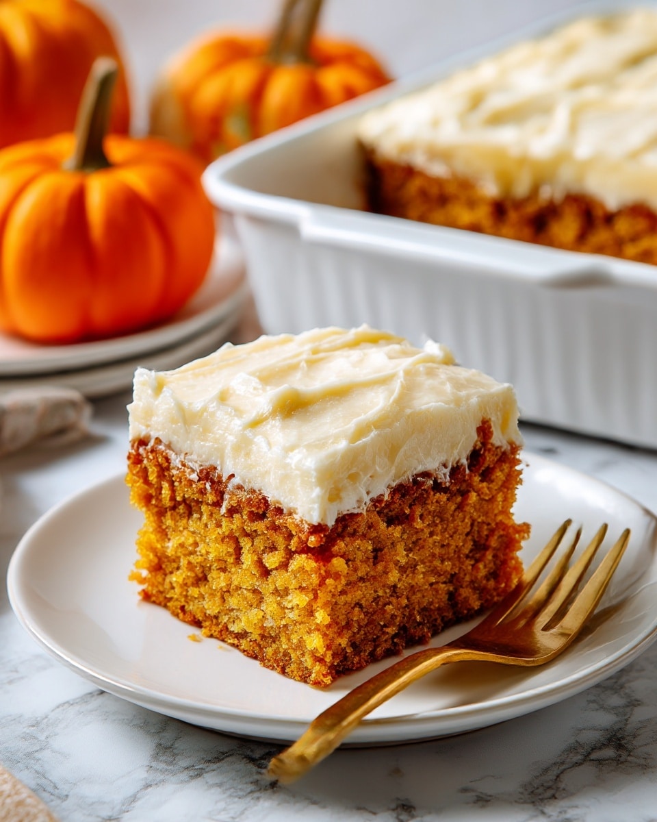 The image shows a single rectangular piece of pumpkin cake with one layer, placed on a white plate. The cake’s bottom layer is light brown with a soft and spongy texture, and it is topped with a thick, smooth white frosting layer spread evenly over the top. A gold fork lies on the plate, partially under the cake piece. In the background, there are small orange pumpkins and a white baking dish filled with more cake, all set on a white marbled surface. photo taken with an iphone --ar 4:5 --v 7